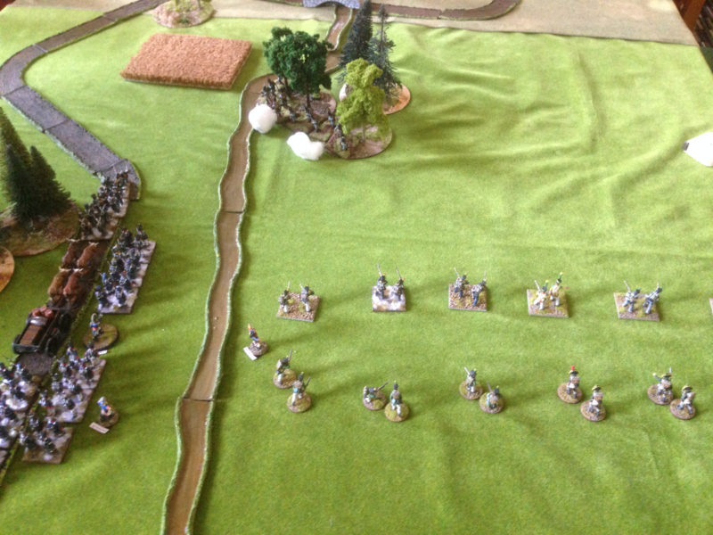 The French column advances, receiving fire from the defending Austrians in the woods.